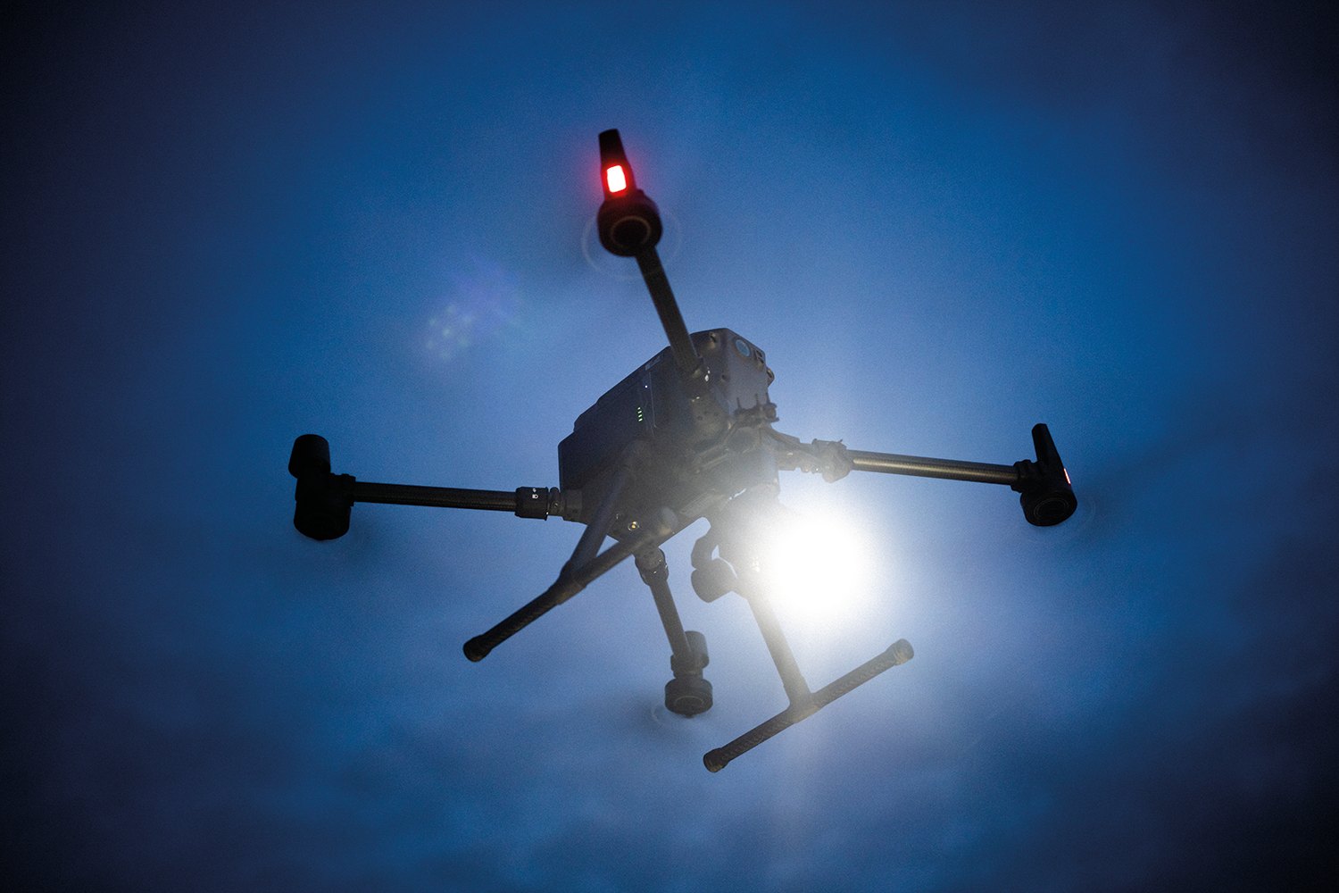 Drone with light in night sky